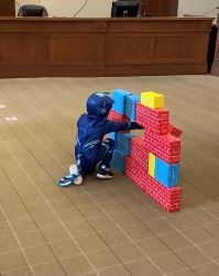 Picture of boy knocking down blocks
