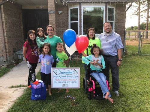 A family standing in front of their home
