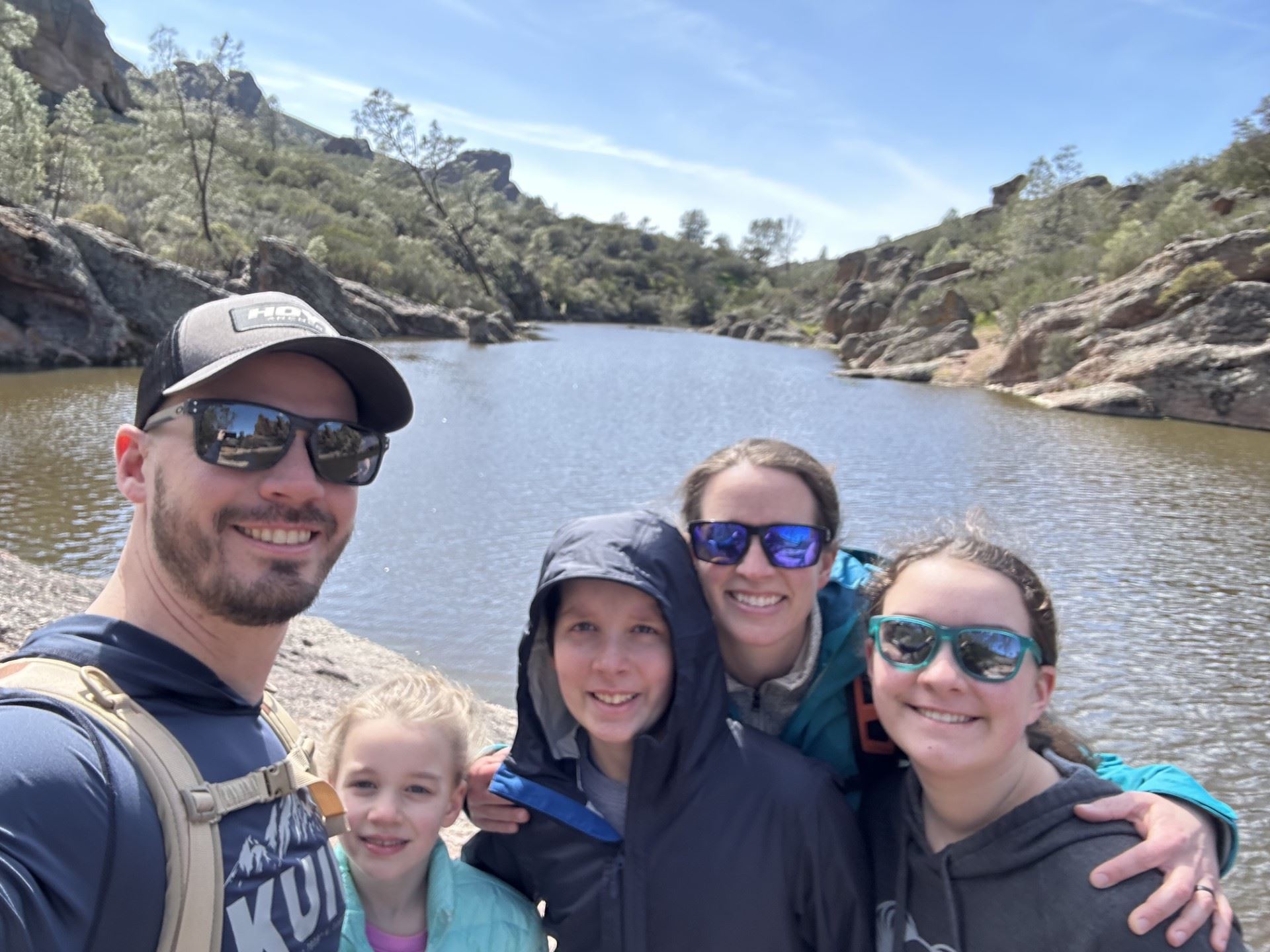 The Hunt Family smiling against a backdrop of a river