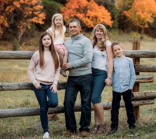 A family of five in a autumn setting. 